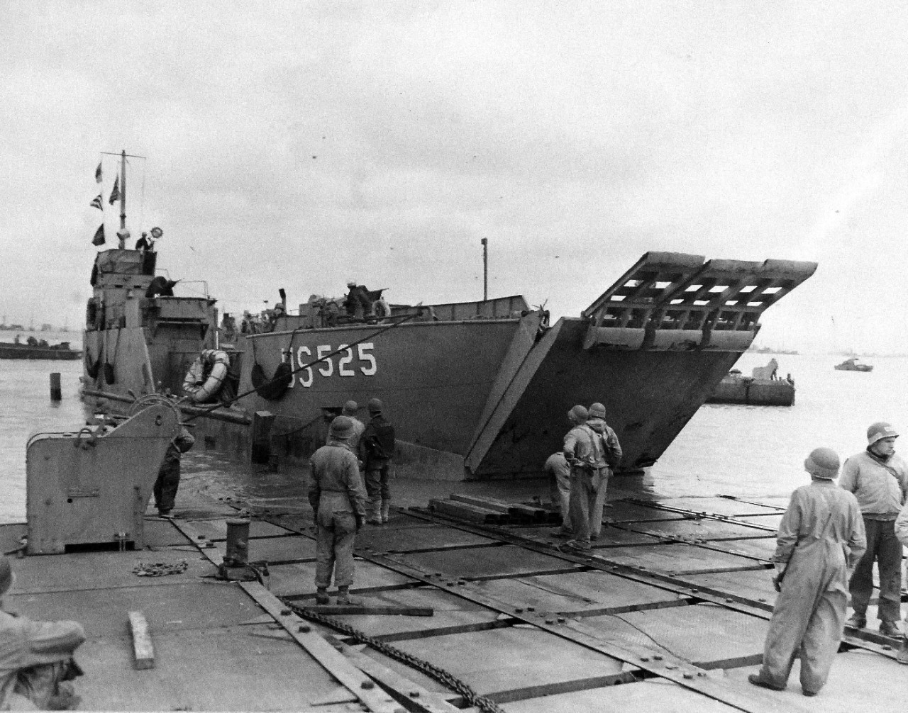 LCT 525 unloads at the the pontoon causeway at “Omaha” beach